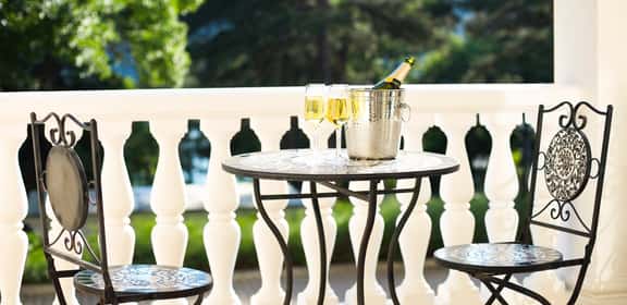 Calici e bottiglia di Champagne in ghiaccio su terrazza elegante